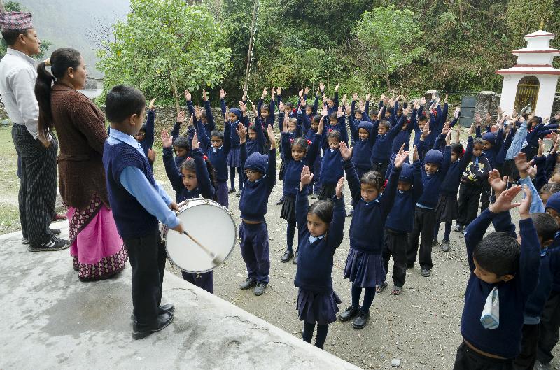 Photo Les enfants népalais qui s'adonnent à des exercices de tambour lors d'un rassemblement en plein air dans une école rurale, Lwang Ghalel, Annapurna Conservation Area, Himalayas (Népal)